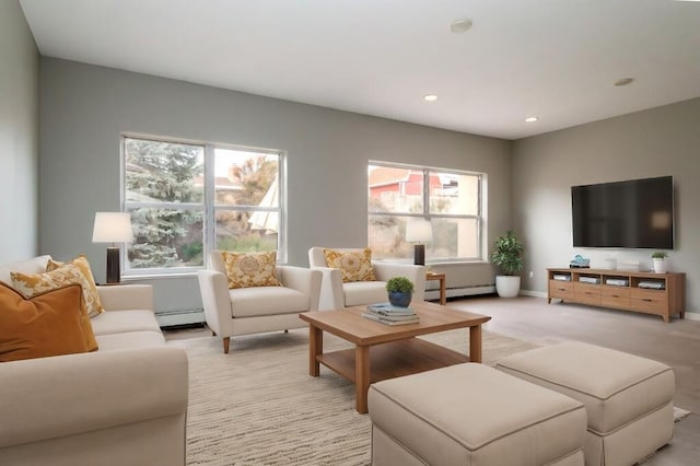 living room with baseboard heating and light carpet