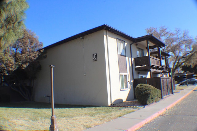 view of side of home with a balcony