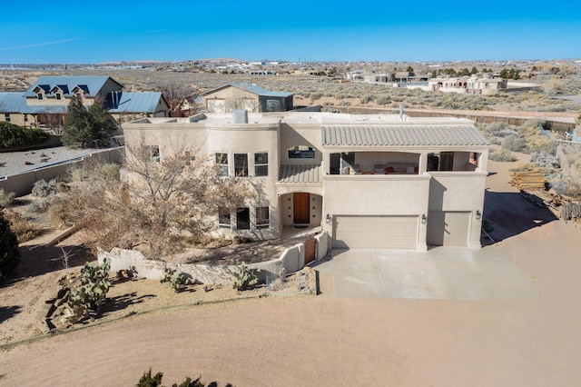 view of front of house featuring a garage and a balcony