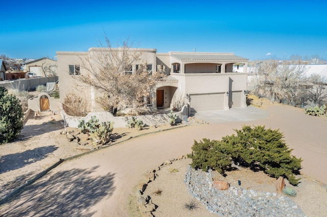 view of front of house featuring a balcony and a garage