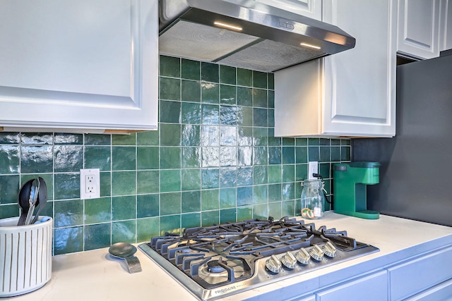 kitchen with white cabinetry, stainless steel gas cooktop, and decorative backsplash