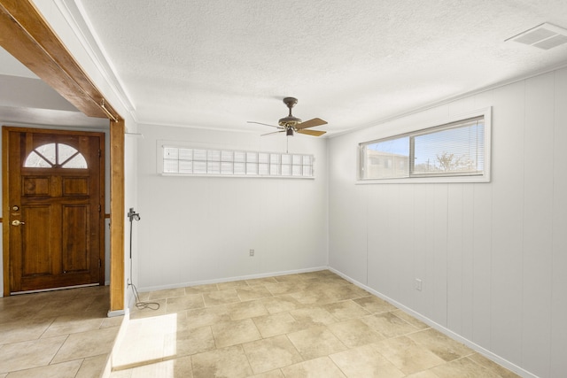 entryway with a textured ceiling and ceiling fan