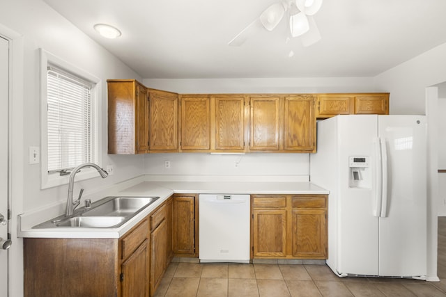 kitchen featuring ceiling fan, sink, light tile patterned floors, and white appliances