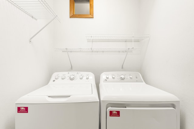 laundry room featuring washing machine and clothes dryer