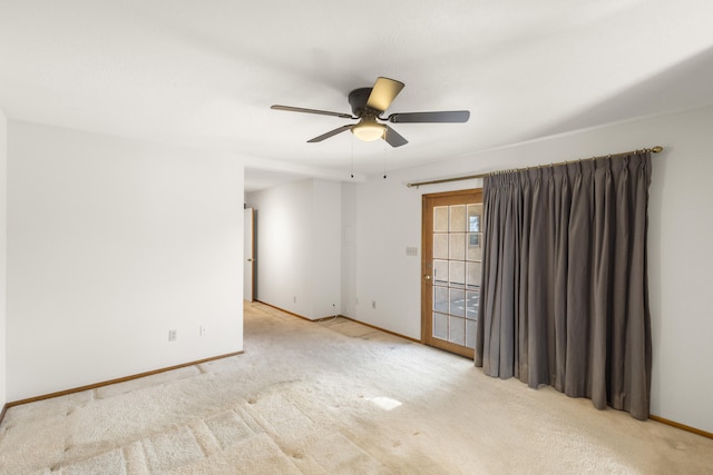 spare room featuring ceiling fan and light colored carpet