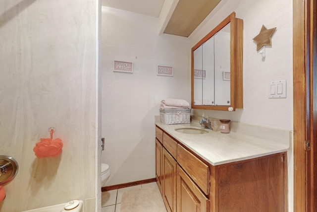 bathroom with tile patterned flooring, vanity, and toilet