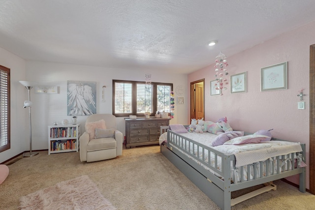 carpeted bedroom with a textured ceiling