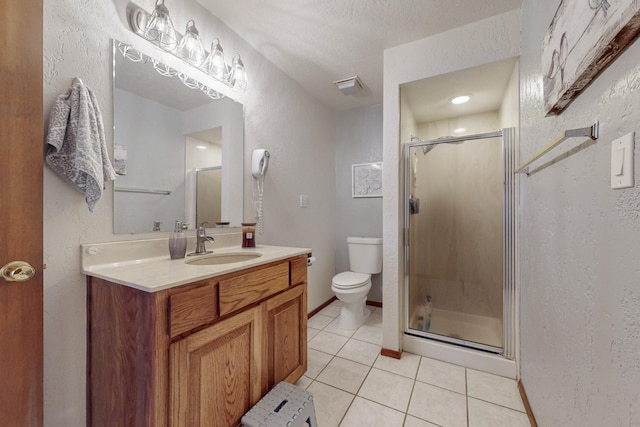 bathroom featuring a shower with door, vanity, and tile patterned flooring