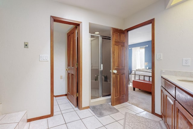 bathroom with tile patterned flooring, walk in shower, and vanity