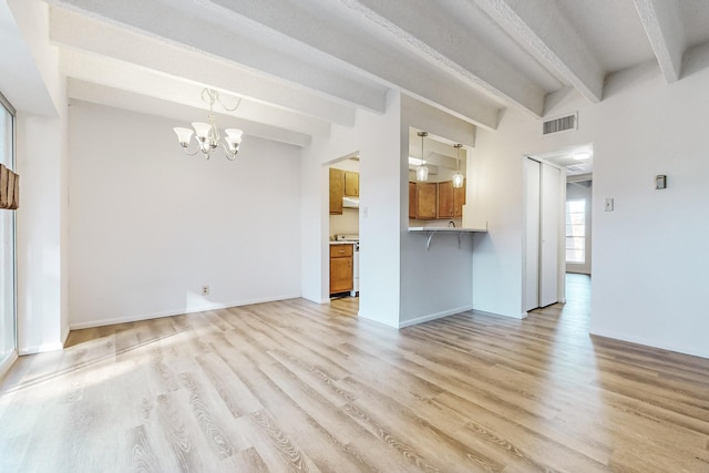 unfurnished living room featuring beamed ceiling, light hardwood / wood-style floors, and a chandelier