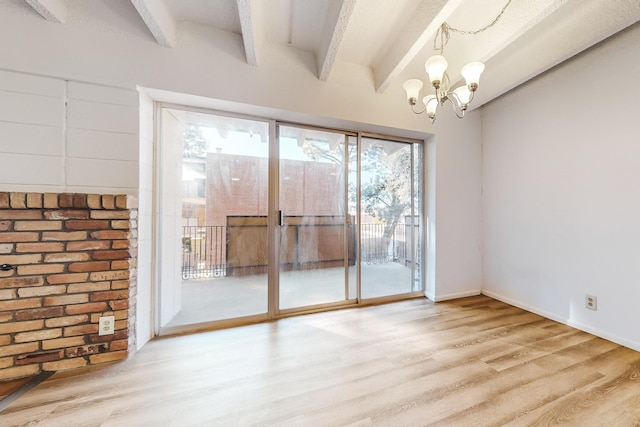 interior space with a wealth of natural light, hardwood / wood-style floors, and a chandelier