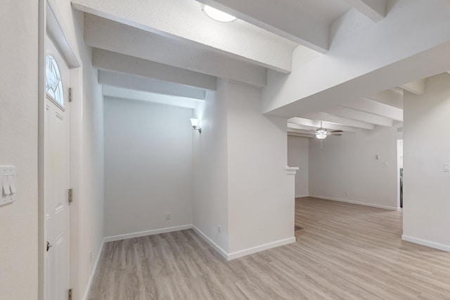 basement with ceiling fan and light wood-type flooring