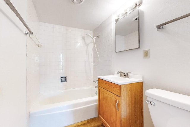 full bathroom featuring wood-type flooring, vanity, toilet, and tiled shower / bath