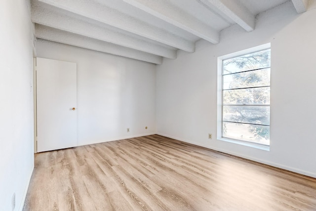 interior space featuring beam ceiling and light hardwood / wood-style flooring