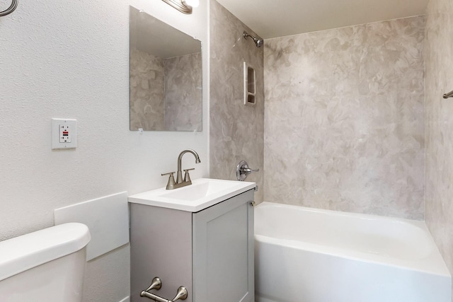 full bathroom featuring vanity, toilet, and tiled shower / bath