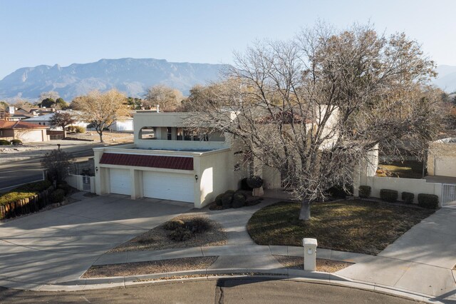 view of front facade with a mountain view and a garage