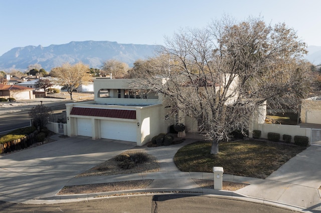 9420 Layton Ct NE, Albuquerque, NM 87111 - view of front of property with a garage and a mountain view