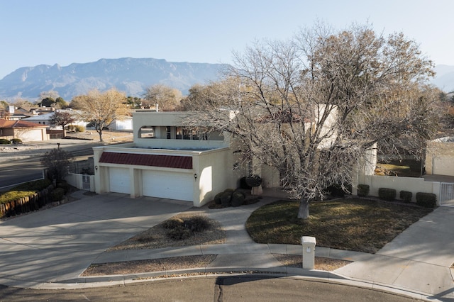 view of front of property with a garage and a mountain view