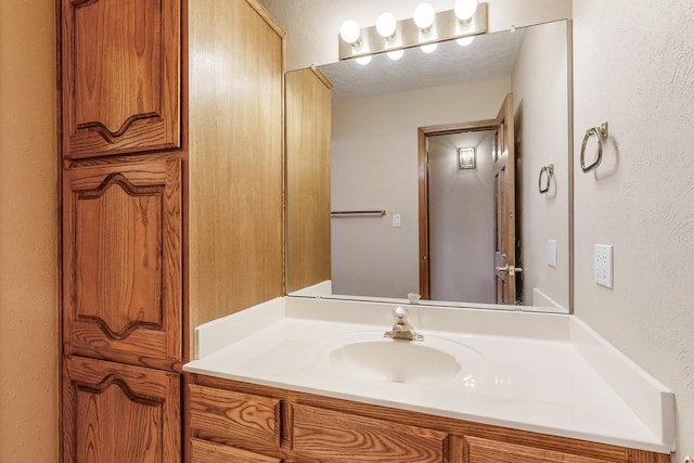 bathroom featuring vanity and a textured ceiling