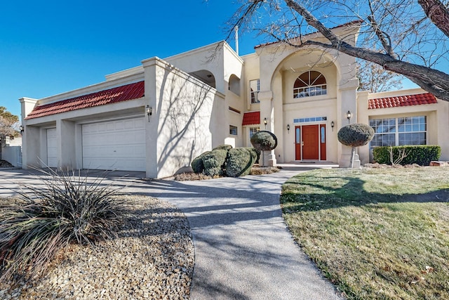 view of front of property featuring a garage and a front yard