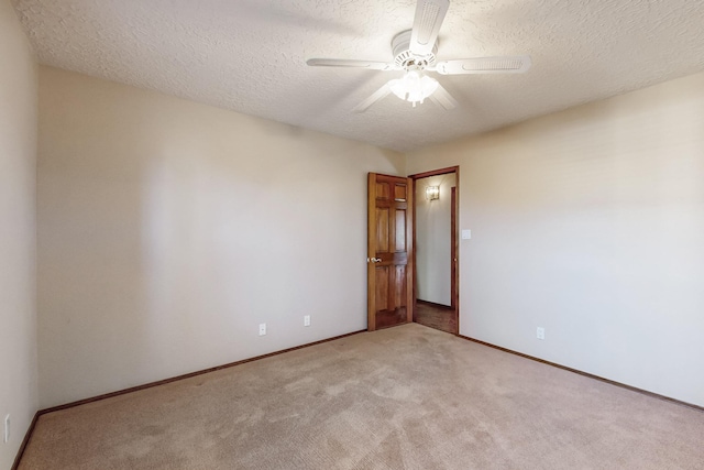 unfurnished room featuring light carpet, a textured ceiling, and ceiling fan