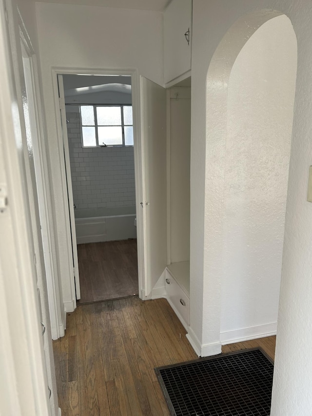 corridor with dark hardwood / wood-style floors