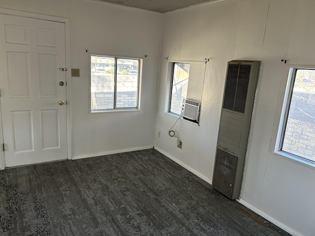 interior space with dark hardwood / wood-style floors, a healthy amount of sunlight, and cooling unit