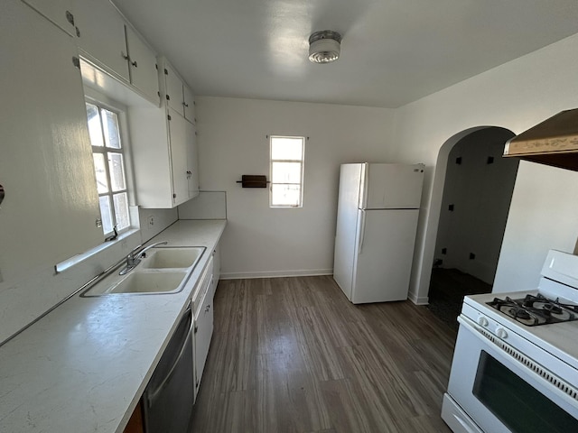 kitchen featuring white appliances, white cabinetry, a healthy amount of sunlight, and sink