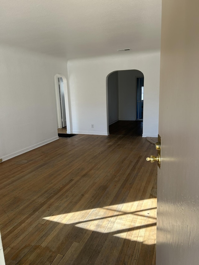 empty room featuring dark wood-type flooring