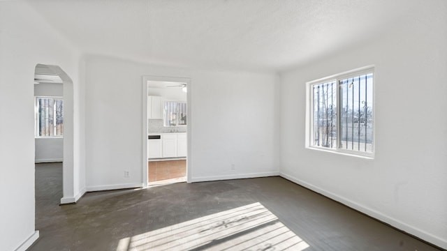 spare room featuring ceiling fan and a textured ceiling