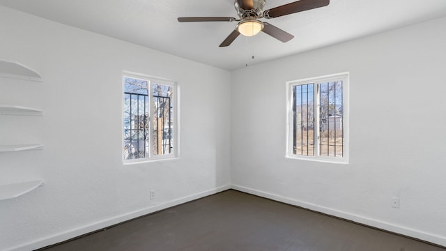 spare room featuring plenty of natural light and ceiling fan