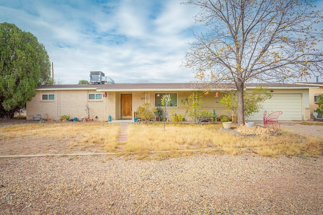 single story home featuring a garage and central AC unit