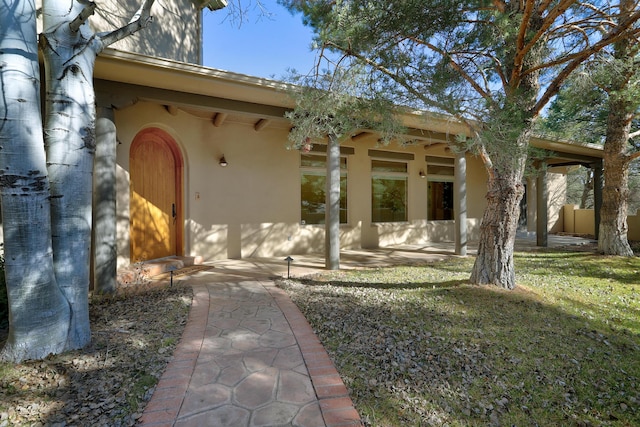 doorway to property featuring a yard