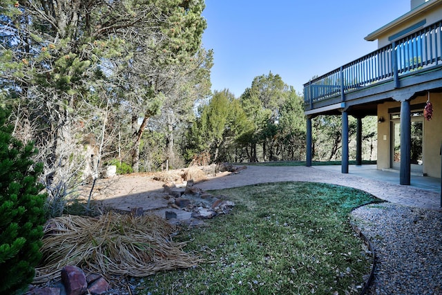 view of yard with a patio area and a deck