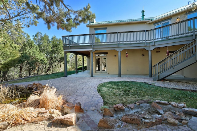 rear view of property with a patio area, french doors, and a deck