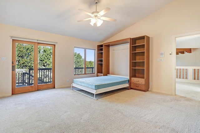 unfurnished bedroom featuring carpet, access to outside, ceiling fan, and lofted ceiling