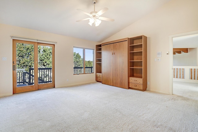 unfurnished bedroom with access to exterior, carpet, vaulted ceiling, ceiling fan, and a closet