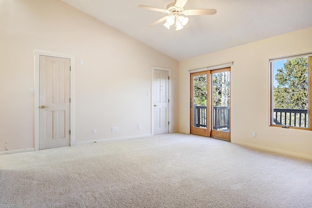 spare room featuring light colored carpet, high vaulted ceiling, and ceiling fan