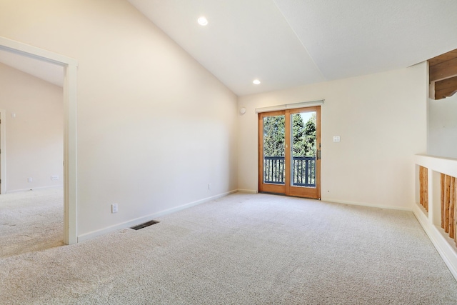 carpeted spare room featuring high vaulted ceiling