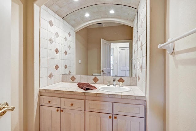 bathroom with vanity and backsplash