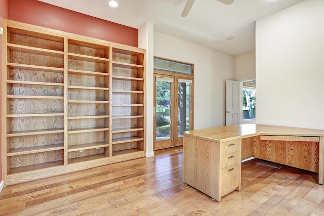 unfurnished office with ceiling fan and light wood-type flooring