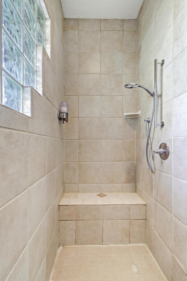 bathroom featuring a tile shower