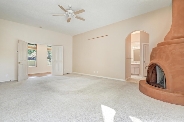 carpeted living room with ceiling fan