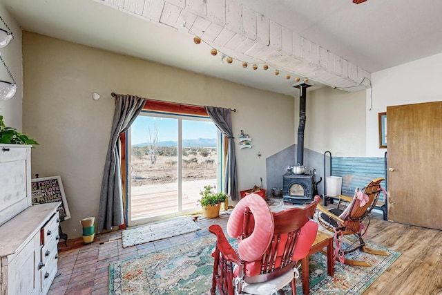 interior space with a mountain view, light wood-type flooring, and a wood stove