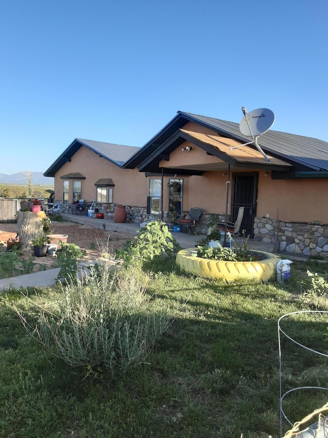 6284 State Highway 55, Mountainair, NM 87036 - rear view of house featuring stucco siding, stone siding, a patio area, and a mountain view