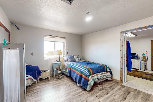 6284 State Highway 55, Mountainair, NM 87036 - bedroom with wood finished floors and a textured ceiling