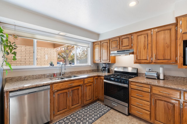 kitchen featuring light tile patterned flooring, stainless steel appliances, and sink