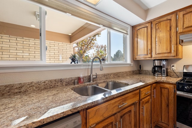 kitchen featuring ventilation hood, sink, light stone countertops, and stainless steel appliances