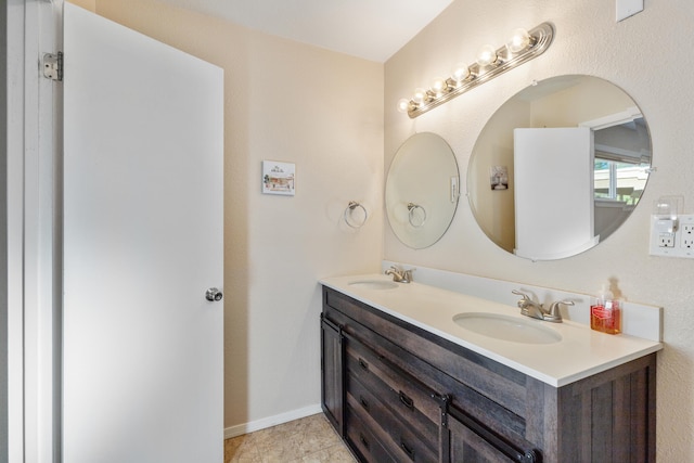 bathroom with tile patterned flooring and vanity