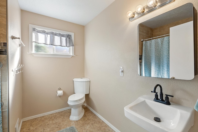 bathroom featuring tile patterned flooring, a shower with curtain, toilet, and sink